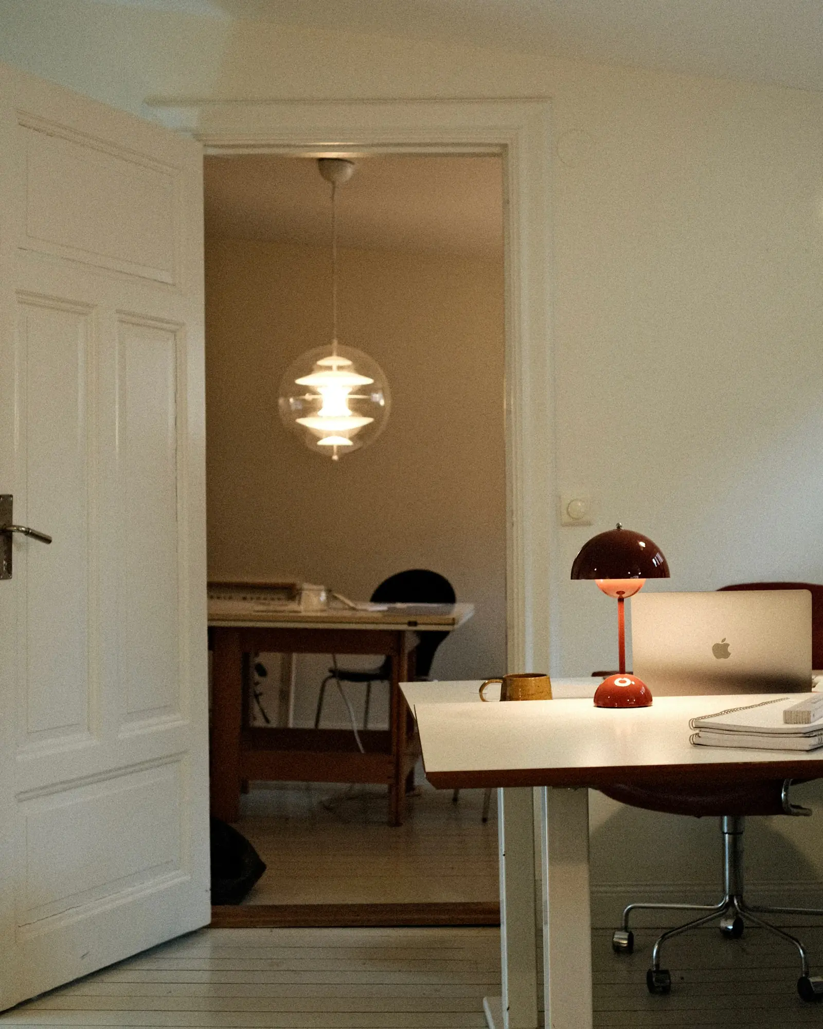 Inside Several's design studio in Stockholm: desks, a laptop and warm lamps