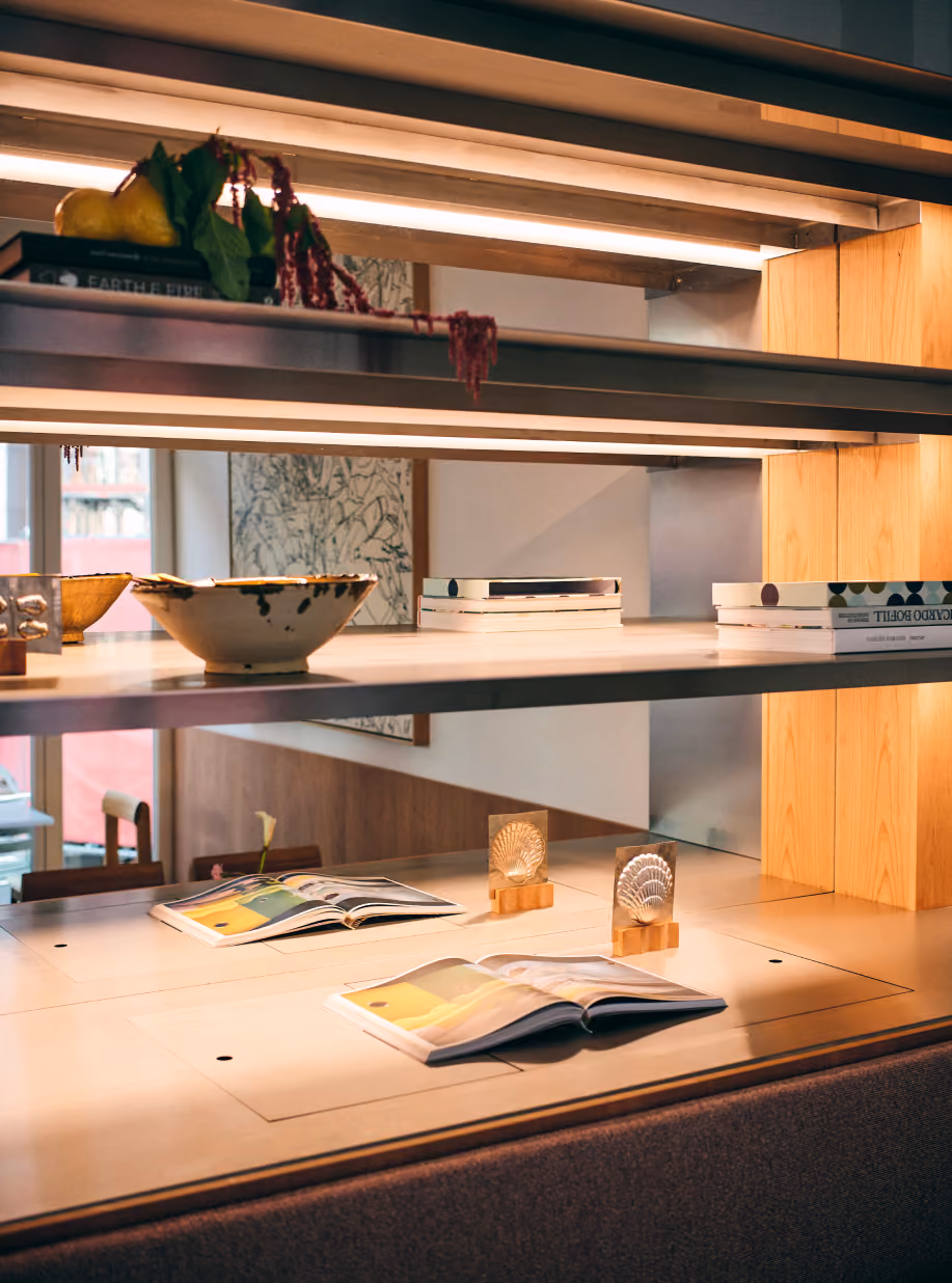 Shelves at STROM with books, ceramics and open magazines