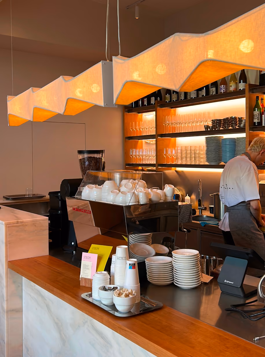 STROM's cafe counter with espresso machine and sculptural fabric lamp