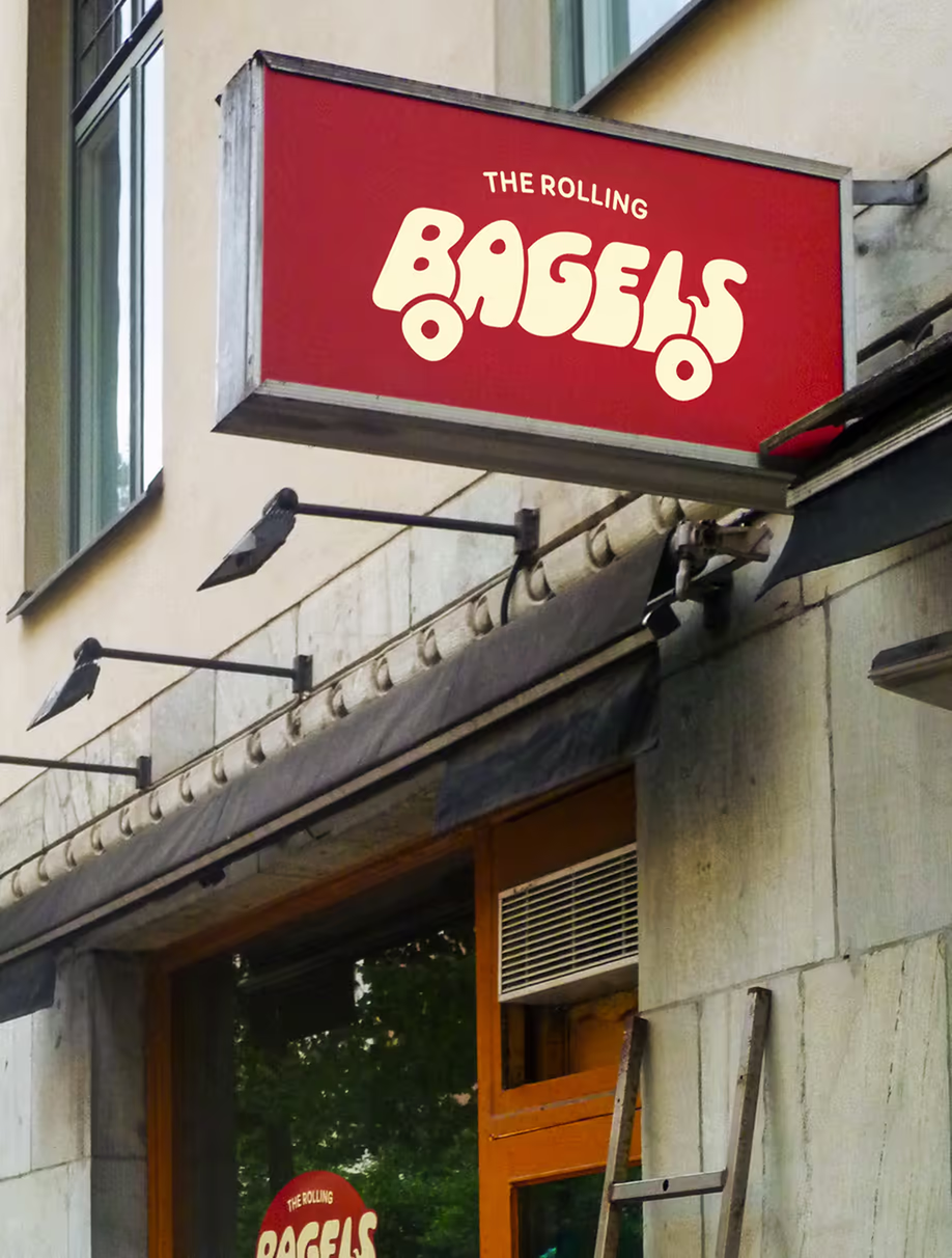 Illuminated Rolling Bagels sign above the shop entrance