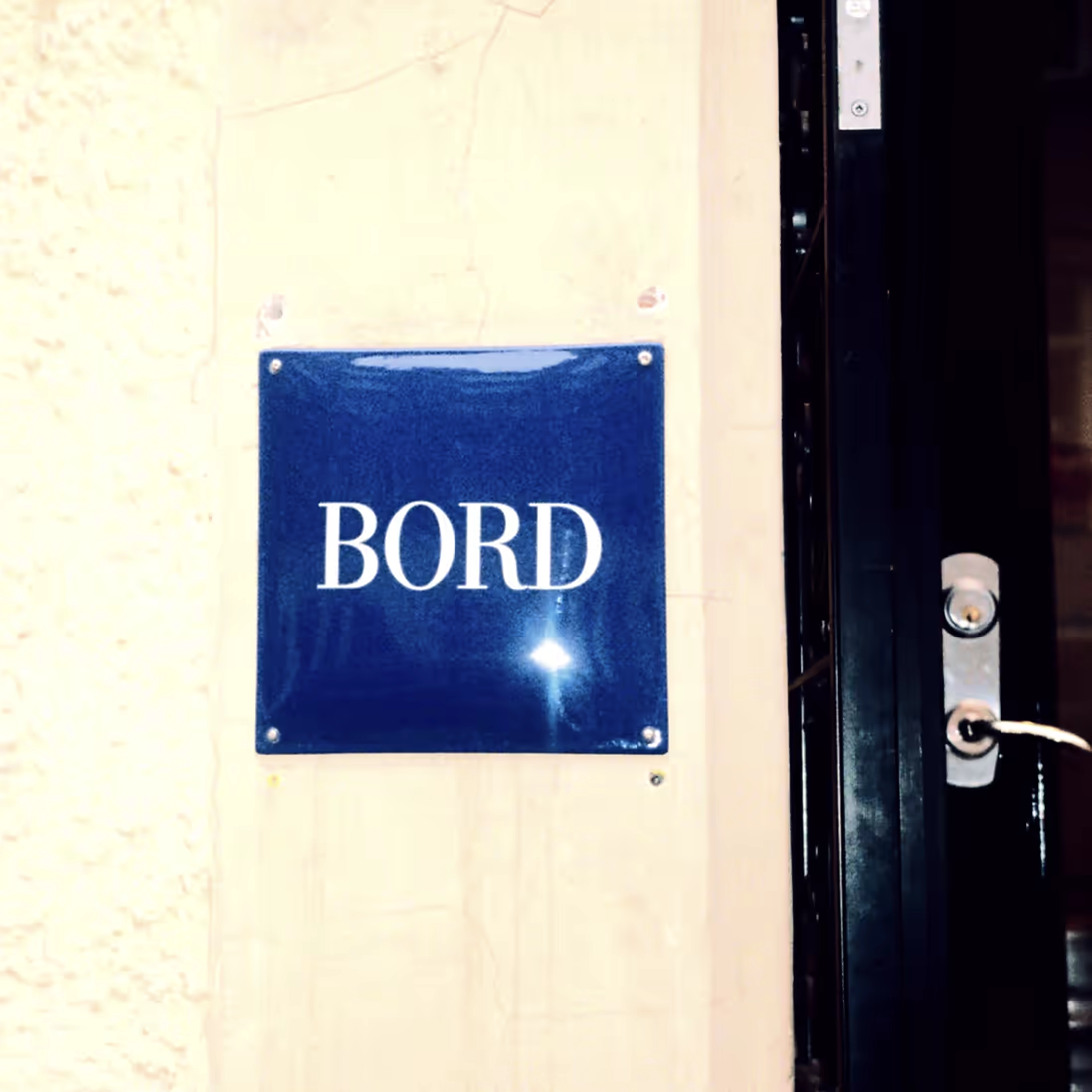 Blue enamel BORD sign at the restaurant entrance
