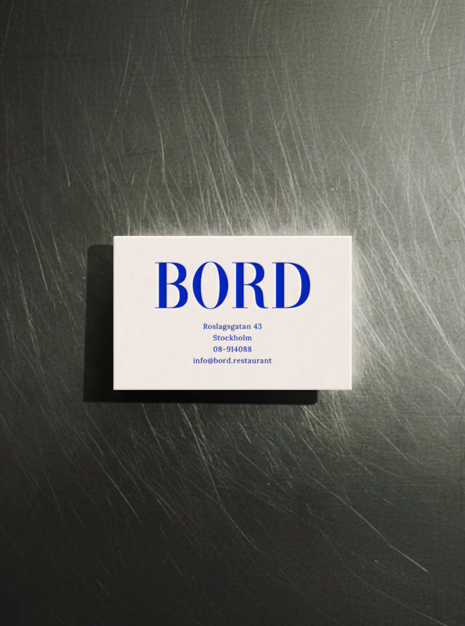 Bord business card with the blue serif logotype on a brushed steel counter