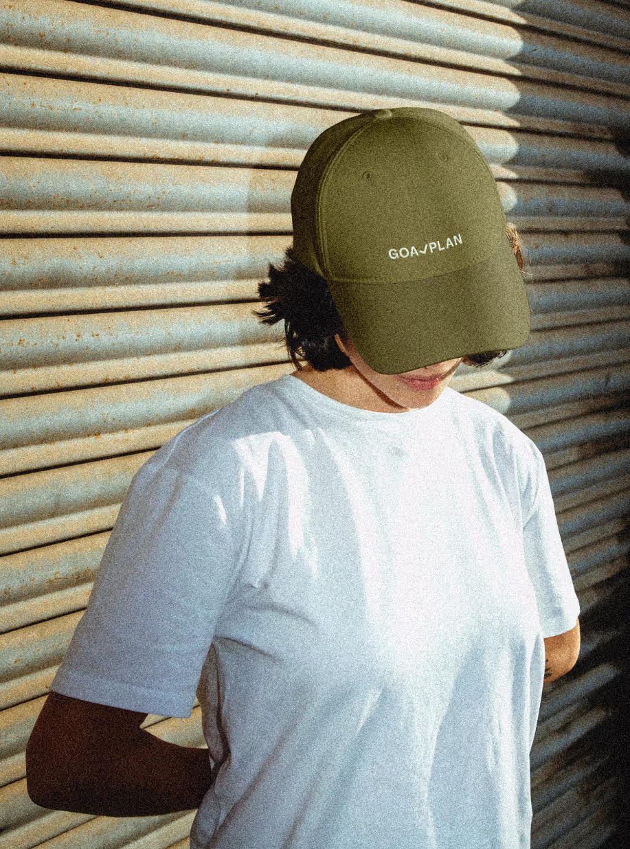 Woman with Goalplan cap in new brand identity colors