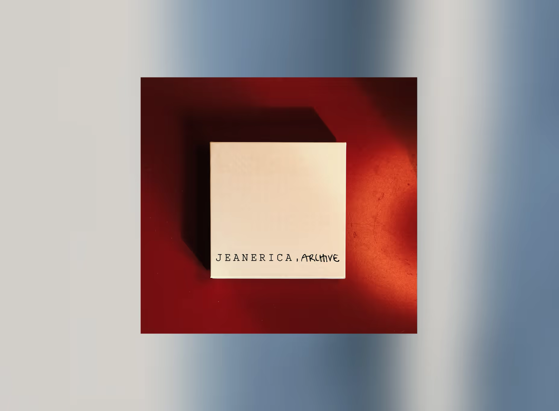 Cream gift box printed 'Jeanerica, Archive' on a red background