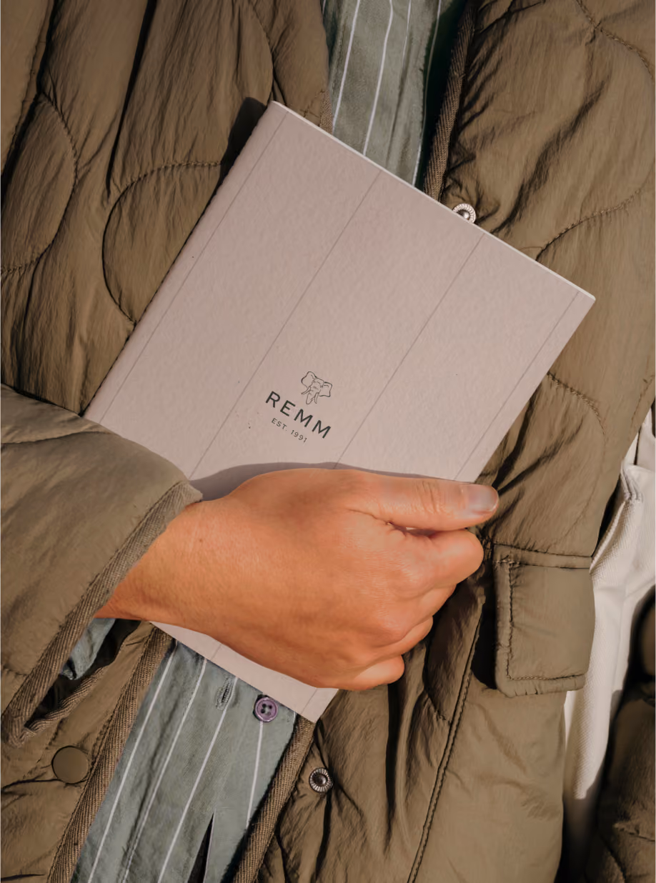 Hand holding a REMM-branded brochure