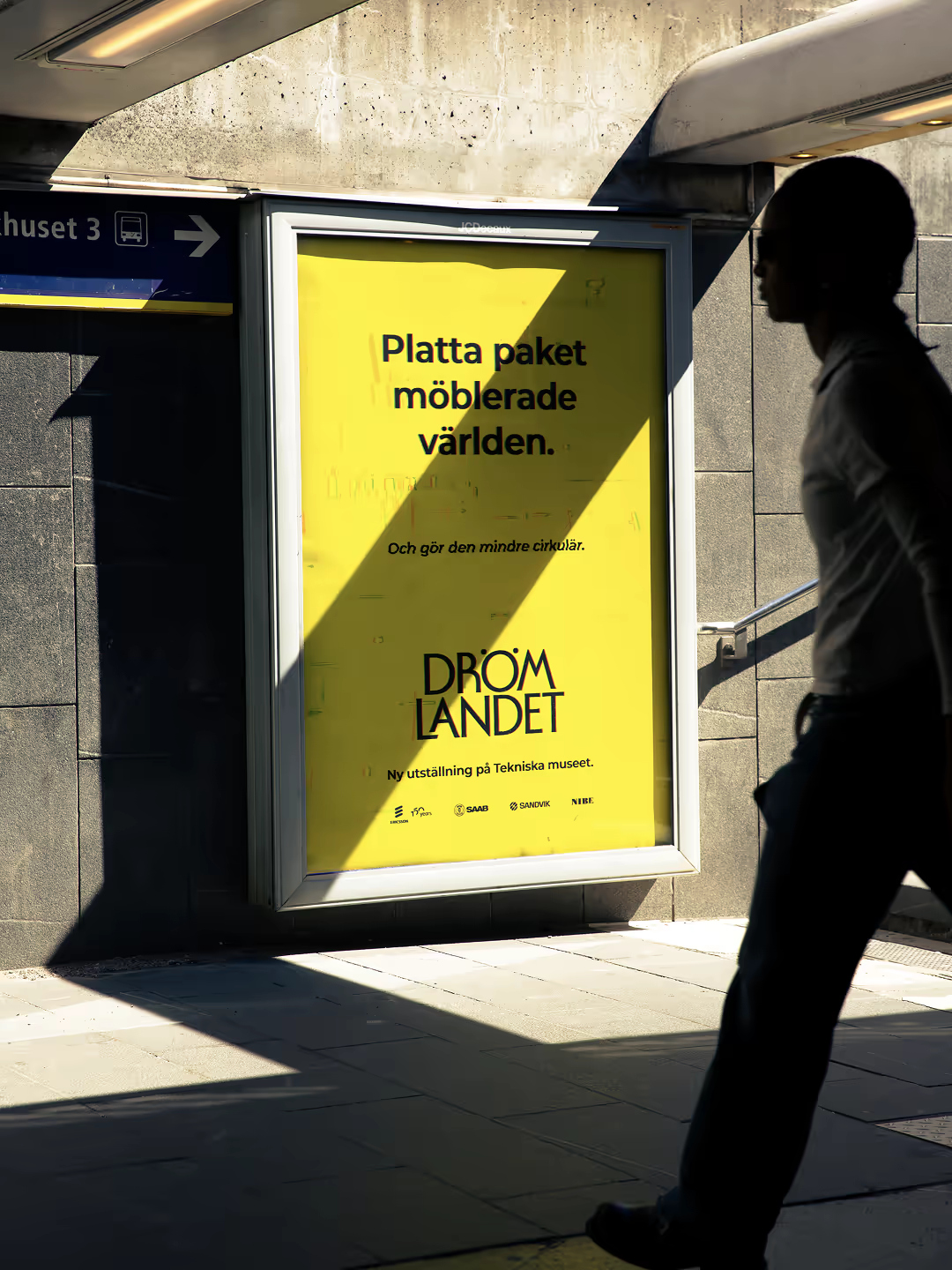 Drömlandet bus stop poster with a passer-by in silhouette